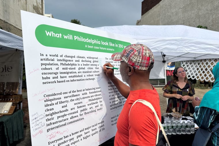 Over the past two years, nearly 1,000 Philadelphians have shared their vision for Philadelphia 250 years in the future at festivals, community events, and small-group gatherings across the city. Here, a participant in the Northern Liberties Second Street Festival writes down their ideas in 2024.