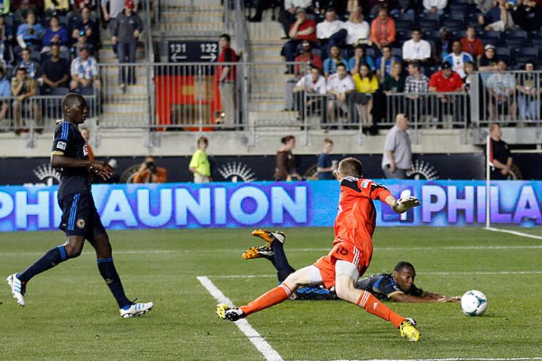 The Union's Bakary Soumaré, Zac MacMath and Raymon Gaddis (from left to right) watch a shot by Los Angeles' Hector Jimenez head into the net. (Yong Kim/Staff Photographer)