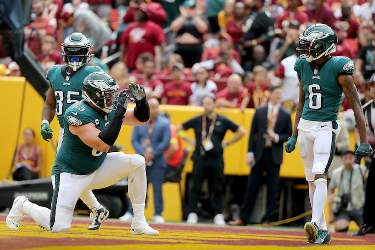 Eagles tackle Lane Johnson pretending to take a photo of wide receiver DeVonta Smith after he caught a touchdown pass late in the second quarter Sunday.