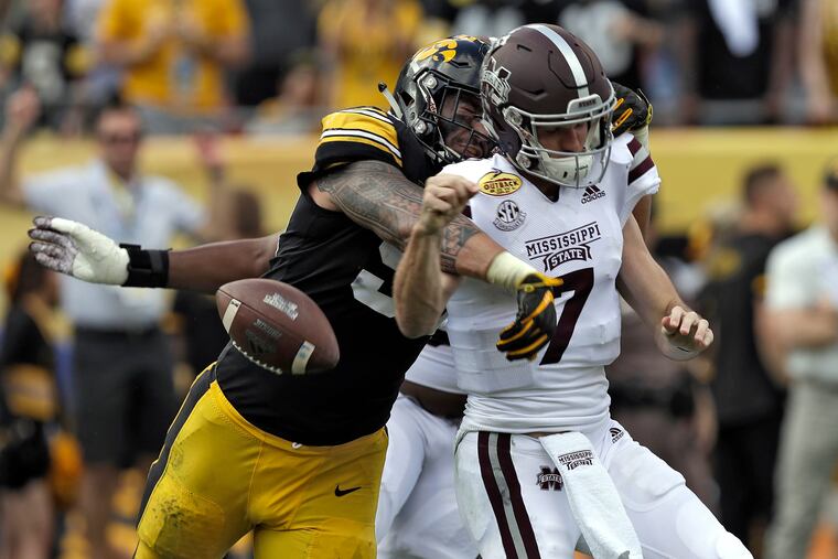 Iowa defensive end A.J. Epenesa (94) strips the ball from Mississippi State quarterback Nick Fitzgerald (7) last season. He will be out to cause similar trouble for Penn State on Saturday.