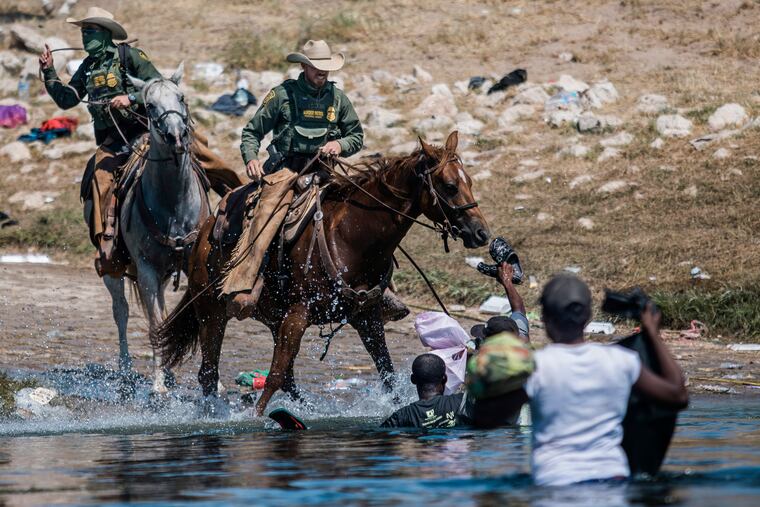 Mounted U.S. Border Patrol agents attempt to contain migrants as they cross the Rio Grande from Ciudad Acuña, Mexico, into Del Rio, Texas, in September.