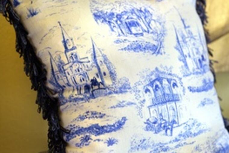 Toile pillow from Hazelnut New Orleans depicts street scenes. Sales have been brisk since Hurricane Katrina.
