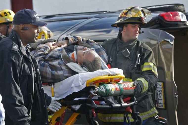 A crash at Godfrey and Ogontz Avenues in North Philadelphia injured two Philadelphia police officers and a civilian. Here rescue workers transport one of the men hurt in the crash. (Alejandro A. Alvarez / Staff Photographer)