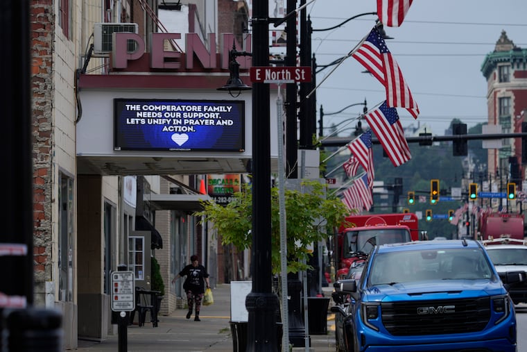 A memorial for Corey Comperatore is seen on a billboard at the Penn Theater in Butler, Pa. Comperatore was killed at rally for former President Donald Trump Saturday.