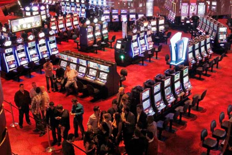At 11:30 pm, people hang aoround the entrance to HQ Nightclub with not much gambling action happening in the background at Revel Casino in Atlantic City on November 30, 2012. ( ELIZABETH ROBERTSON / Staff Photographer )