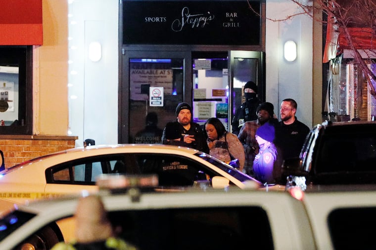Police escort people out of Steppy’s Sports Bar and Grill at the Our Town Alley bowling alley in East Norriton, Pa. on Feb. 20, 2021. A shooting occurred at this location earlier in the evening.