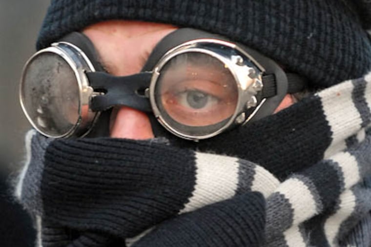 Matthew Rolls. 24, of West Philadelphia was bundled up against the cold this morning at the SEPTA bus stop at 15th Street & John F. Kennedy Boulevard )