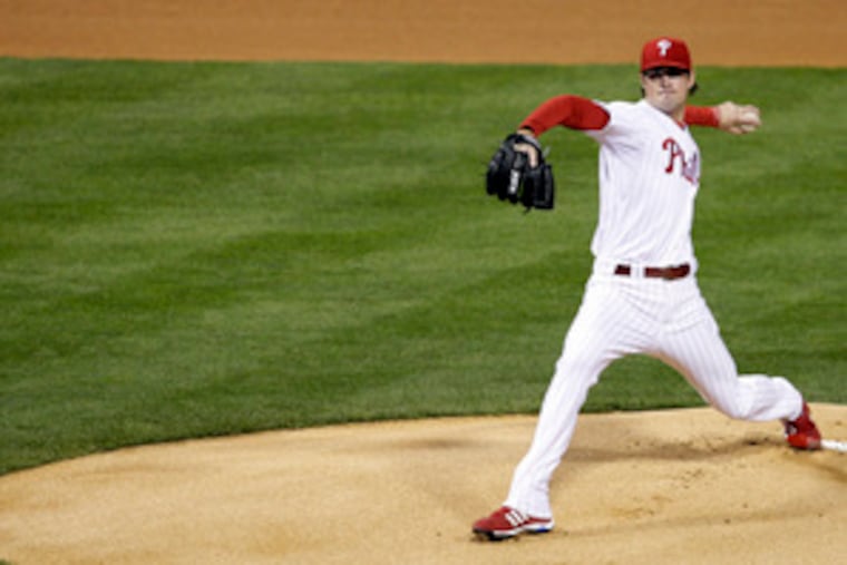 Phillies starter Cole Hamels throws the first pitch of the National League Championship Series. Hamels gave up a run in the inning on back-to-back doubles by Andre Ethier and Manny Ramirez.