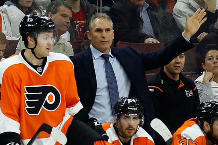 Craig Berube waves goalie Steve Mason to the bench. (Yong Kim/Staff Photographer)