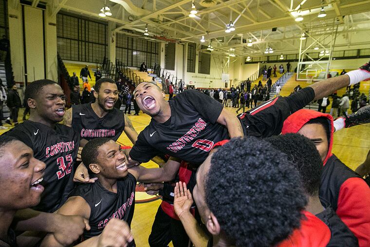 Constitution's Tamir Green leaps onto his teammates after Constitution defeated King.