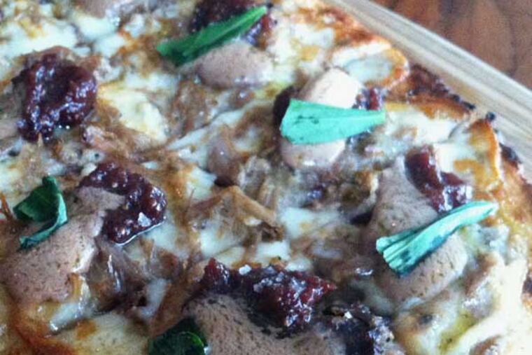 The wood-grilled flatbread with gorgonzola, duck confit, cherry-fig mostarda, and foie gras mousse from Tria Taproom (2005 Walnut St.)