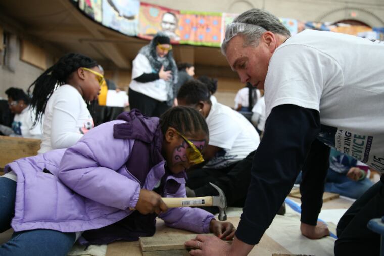 Frank Monaghan, executive director of Habitat for Humanity, right, helps Janai Wright, 9, left, build a flower box during 20th annual Greater Philadelphia Martin Luther King Day of Service at Girard College in Philadelphia, Pa. on January 19, 2015.