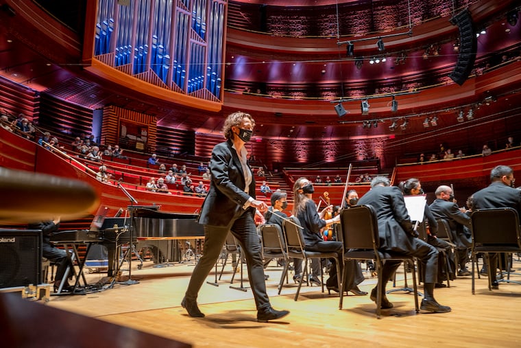 Nathalie Stutzmann walks onstage at Verizon Hall on Dec. 2, 2021, as she makes her debut as the Philadelphia Orchestra’s new principal guest conductor.