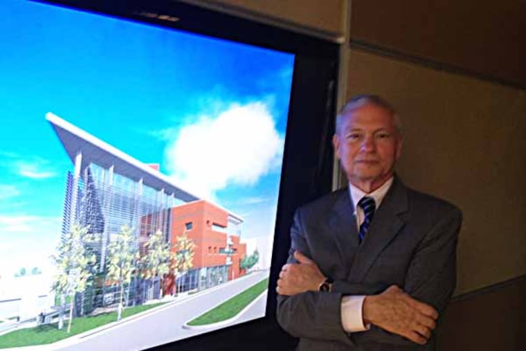 Gary Giamartino, Dean of LaSalle University's School of Business, standing next to architect's rendering of the new School of Business. The architect is Kimmel Bogrette Architecture + Site, Inc. Photo: Michael Hinkelman / Daily News Staff