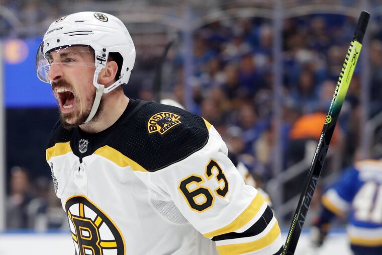 Brad Marchand celebrates after scoring a goal against the St. Louis Blues during the first period on Sunday in St. Louis.