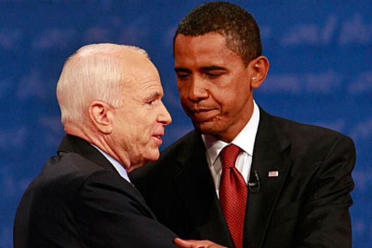 Sen. John McCain (left) and Sen. Barack Obama embrace after the presidential debate last night.