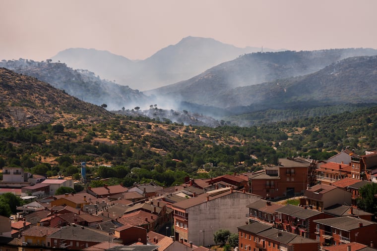 Smoke rises as a wildfire advances near Hoyo de Pinares, Madrid province, Spain, Saturday, July 25, 2026.