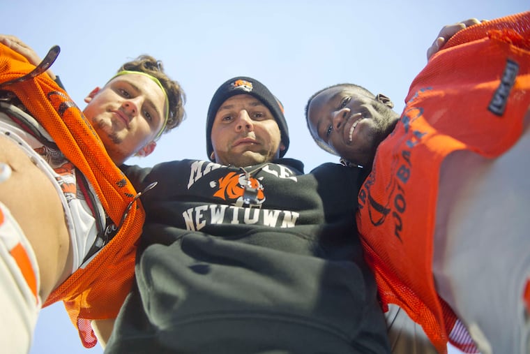 Marple Newtown coach Chris Gicking (center) was once a Tigers star. He is flanked by two-way end Noah Turner (left) and all-purpose player Abel Hoff. AVI STEINHARDT / For The Inquirer
