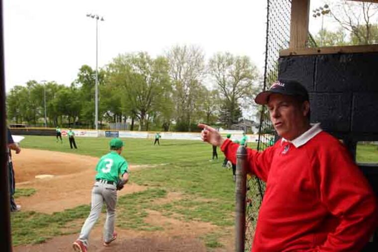 Dan O'Connell, director of the league, talks to one of the parents while one of the teams was practicing. The Morrisville Little League is unwittingly being caught in 2nd Amendment debate, The League director is being forced to cancel about 20 games this saturday since a anti-gun rally is schedule at the park and a pro-gun group may show up bearing arms. ( RON CORTES / Staff Photographer )