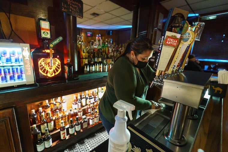 Ana Holloway cleaned up at the end of her shift at the Locust Bar on the last night of indoor dining in Philadelphia last week.