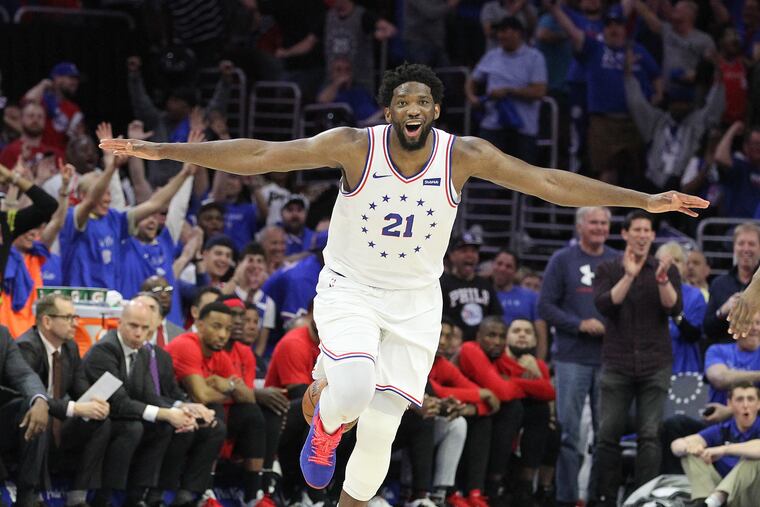 Joel Embiid of the Sixers celebrates as he runs down court after a windmill dunk against the Raptors during the 4th quarter of their NBA playoff game at the Wells Fargo Center on May 2, 2019.