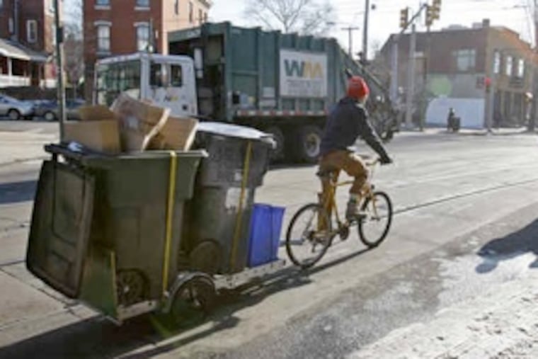 John Paul MacDuffie Woodburn, founder of Pedal Co-Op, transports a load of recyclables after a pickup at the Green Line Cafe on Lancaster Avenue. The firm, with eight riders (or so), also moves compost waste and furniture. (Michael S. Wirtz / Staff Photographer)