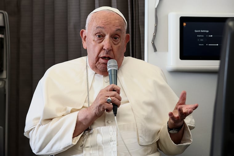 Pope Francis holds a news conference aboard the papal plane on his flight back after a 12-day journey across Southeast Asia and Oceania.
