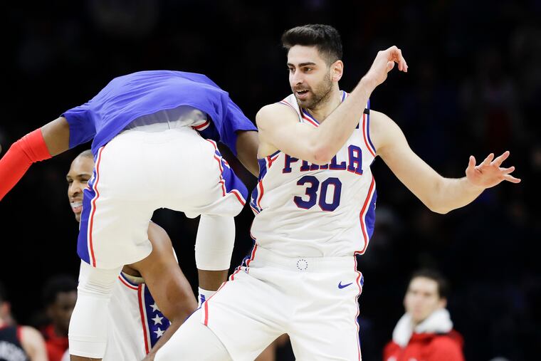 Sixers guard Furkan Korkmaz celebrates his dunk with teammate guard Josh Richardson.