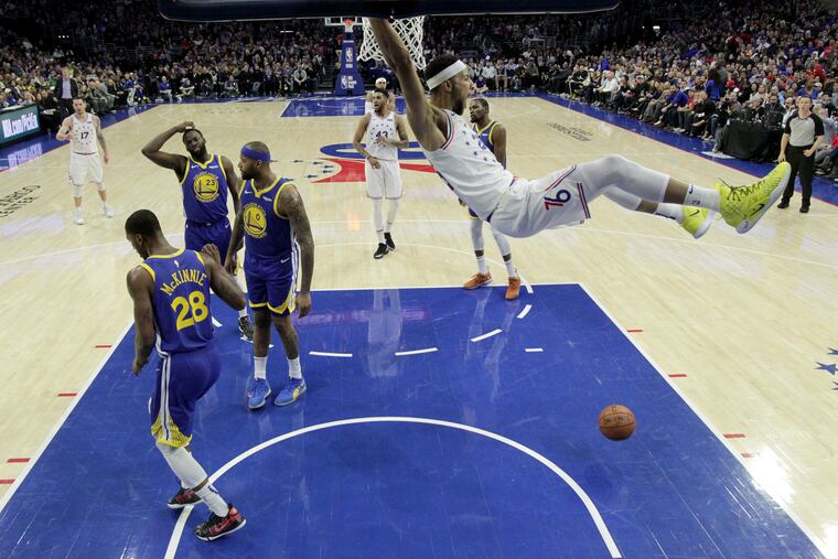 Ben Simmons celebrates after a first half dunk against the Warriors at the Wells Fargo Center on Saturday.
