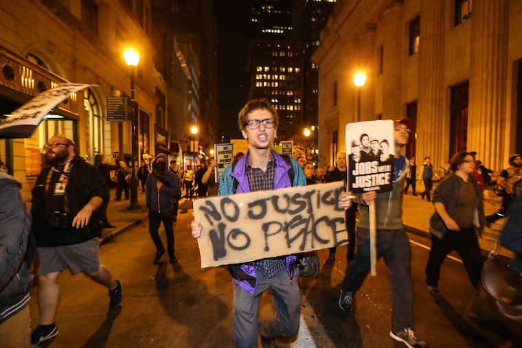 Marching on Chestnut street after the Ferguson verdict, Monday, November 24, 2014. Steven M. Falk / Staff Photographer )