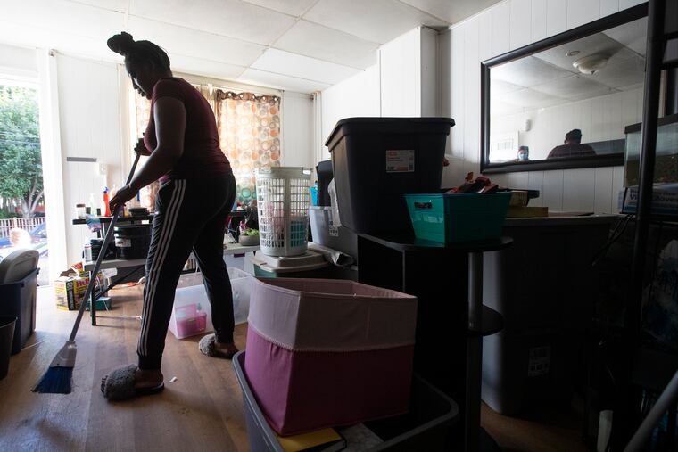 Antoinette Austin-Hunt works cleaning and packing in the Second Street house she and her family rents in Bridgeport, PA on Sept. 7, 2021. Cleanup continues after tropical storm Ida passed over Philadelphia and region.