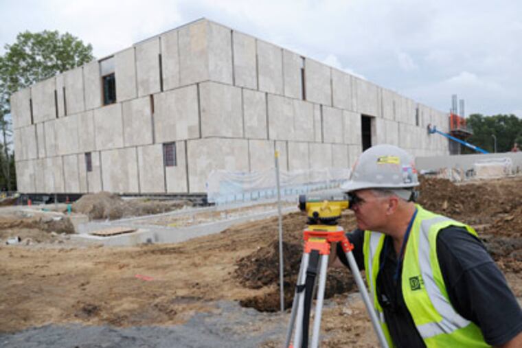 Tom McCarthy of L.F. Driscoll Co. takes a measurement at the Barnes museum site on the Parkway. (Clem Murray / Staff Photographer)