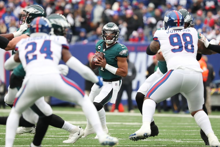Eagles quarterback Jalen Hurts looks for a receiver during the first quarter against New York Giants on Sunday, November 28, 2021 at MetLife Stadium in East Rutherford, New Jersey. Hurts threw an interception on the play.