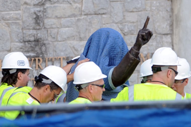 Workers handle the statue of former Penn State football coach Joe Paterno before removing the statue Sunday, July 22, 2012, in State
College, Pa. (AP Photo/John Beale)