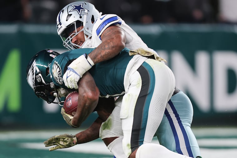 Cowboys linebacker Micah Parsons wrapping up former Eagles running back D'Andre Swift in November. Parsons was impressed by fellow former Penn Stater Saquon Barkley's Eagles debut.