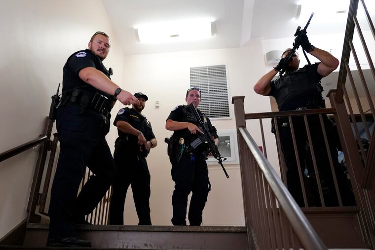 U.S. Capitol Police officers clear a stairwell in the Dirksen Senate Office Building next to the Russell Senate Office Building on Wednesday on Capitol Hill in Washington.