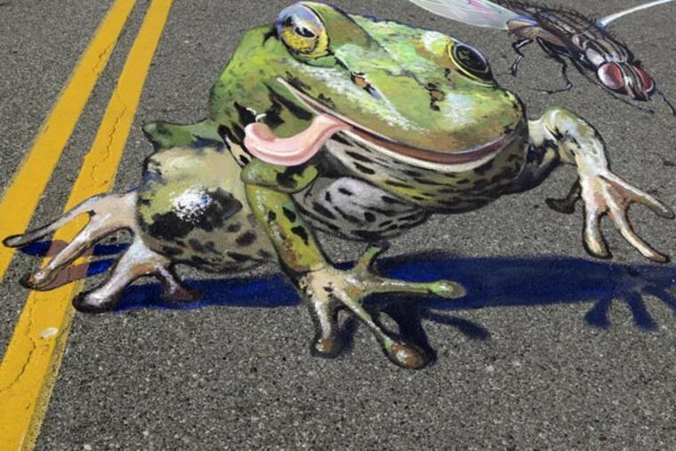 The sidewalk drawing of a frog is by Alex Maksiov from the Ukraine. TOM GRALISH / Staff Photographer