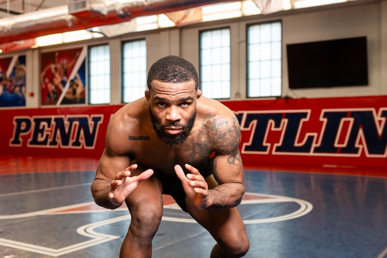 Jordan Burroughs stands guard inside the wrestling room at the University of Pennsylvania in preparation for Team USA's Olympic trials at State College later this month.