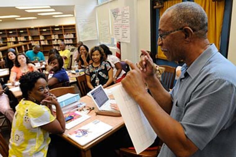 Ethel Allen Elementary School’s principal, Woolworth V. Davis, leads teachers in a professional-development session. “You have to show people that this is different,” he said of those skeptical of the district effort. (CLEM MURRAY / Staff Photographer)