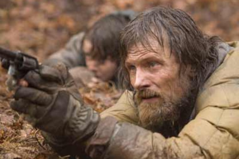In this film publicity image, Viggo Mortensen, right, and Kodi Smit-McPhee are shown in a scene from "The Road." (AP Photo/The Weinstein Company, Macall Polay)