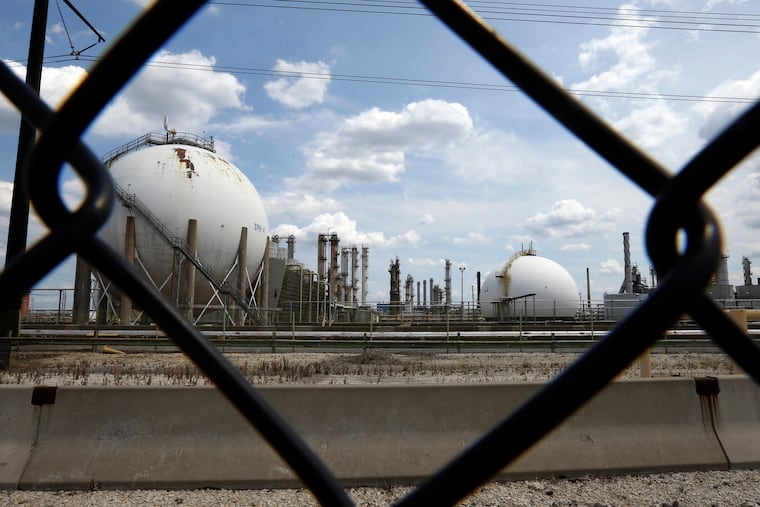 In this image from 2012, the Marcus Hook Refinery is seen through a fence, in Marcus Hook, Pa. The facility operated from 1902 to 2011.