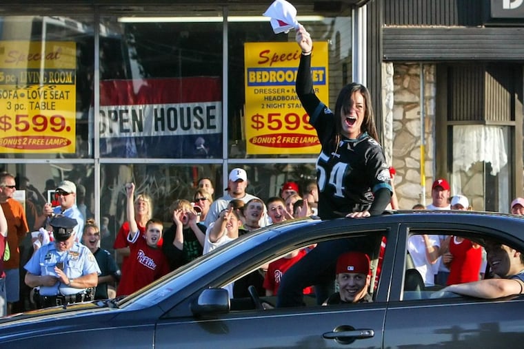 FILE – Fans celebrate the Philadelphia Phillies' first-place finish in the National League East at the intersection of Cottman and Frankford Avenues in Northeast Philadelphia on Sunday, Sept. 30, 2007.