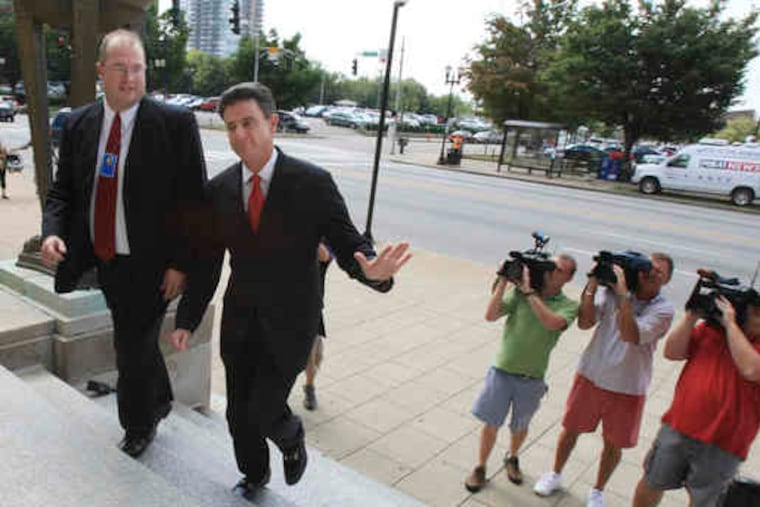 Louisville coach Rick Pitino (right) arrives at the federal courthouse to testify against Karen Cunagin Sypher, left.