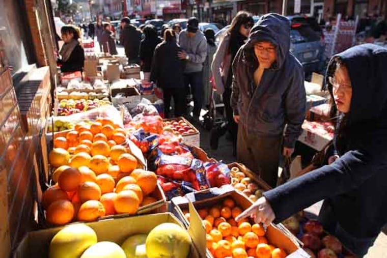 Shoppers in Chinatown were looking for flowers and oranges and special foods to bring in the Year of the Snake. On 10th street these shoppers (didn't speak english ) were looking for oranges, which you give in a red bag with a envelope of money to a relative to wish them good luck for the year. The rest of the world may be focused on snow...Chinatown plans to celebrate New Year's on Sunday and Saturday is an imp day to buy flowers and last minute food items. We will try to capture this color and activity on a potentially challenging weather day 02/09/2013 ( MICHAEL BRYANT / Staff Photographer )