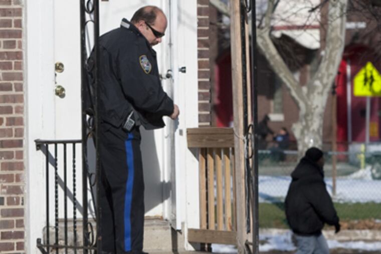 Camden Police Officer B. Segarra secures the apartment on Maple Walk in Camden where 19-year-old Jahmell W. Crockam was arrested early Sunday morning. (Ed Hille / Staff photographer)
