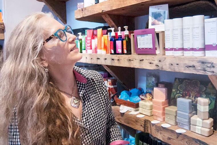 Penny Ordway browses the many offerings in her boutique. Ordway is dedicated to offering many products that are fair trade, organic and non-toxic. (Patrick McPeak / Staff Photographer)
