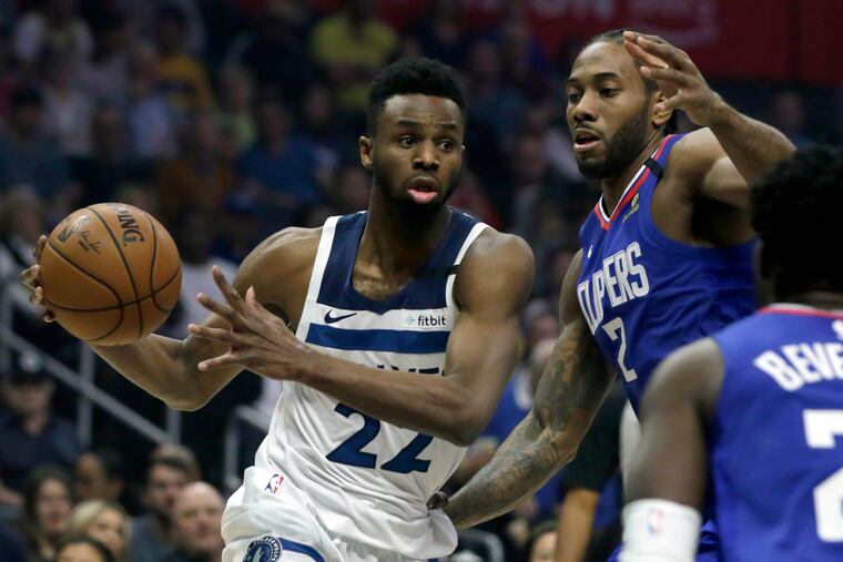 Minnesota Timberwolves guard Andrew Wiggins, left, drives to the basket again Los Angeles Clippers forward Kawhi Leonard (2) during the first half of an NBA basketball game in Los Angeles on Saturday.