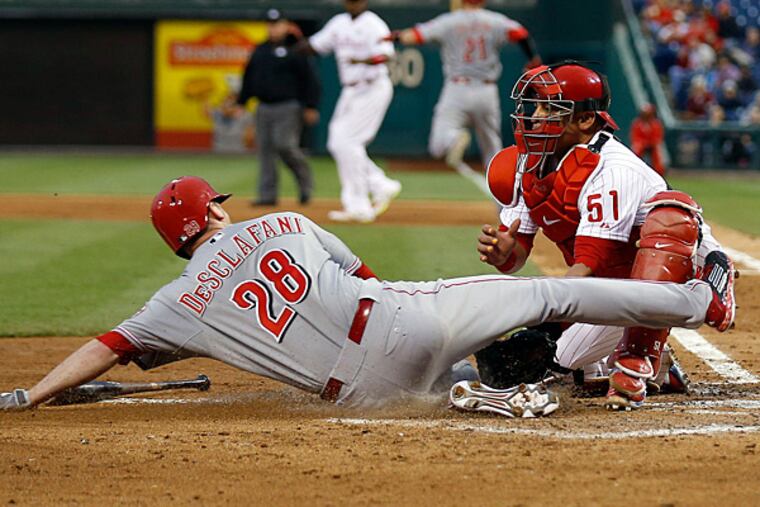 Phillies' catcher Carlos Ruiz tags out Reds ' Anthony DeSclafani at home plate. The call was reversed due to catchers obstruction and a error on Ruiz. (Yong Kim/Staff Photographer)