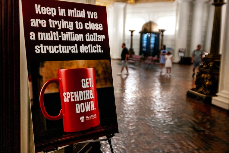 A sign posted by the Pa. Senate at the Pennsylvania State Capitol in Harrisburg on Aug. 26, 2025, reminds visitors of the state’s “multi-billion dollar structural deficit.”