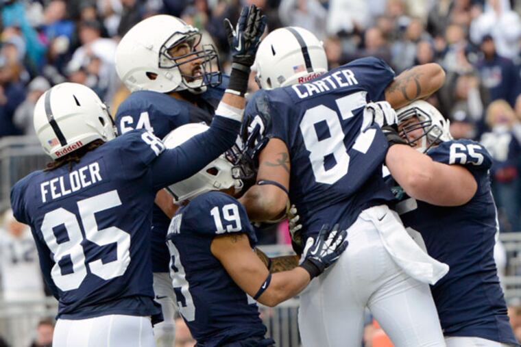 Penn State players celebrate a touchdown catch by Kyle Carter (87) in overtime of an NCAA college football game against Illinois in State College, Pa., Saturday, Nov. 2, 2013. Penn State won 24-17 in overtime. (John Beale/AP)